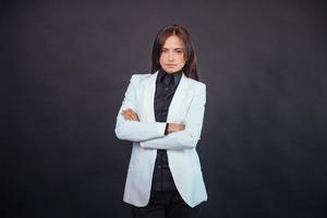 Portrait of beautiful smart young businesswoman in business attire photo