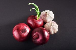 Blue purple onion and garlic isolated white on a black background photo