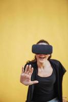 Happy woman gets experience of using VR-glasses virtual reality headset photo