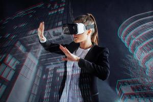 Young girl getting experience VR headset, is using augmented reality eyeglasses, being in a virtual reality. In city at night photo