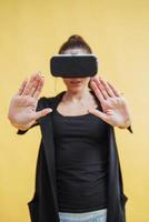 Happy woman gets experience of using VR-glasses virtual reality headset photo