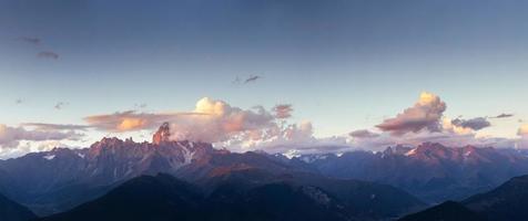 Fantastic snow-capped mountains in the beautiful cumulus clouds photo