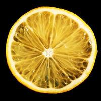 Fresh juicy slices of lemon on a black background photo