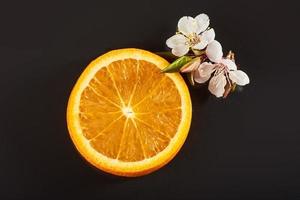 slice ripe orange citrus fruit isolated on a black background. photo