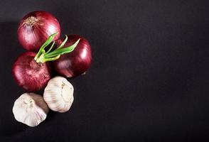 Blue purple onion and garlic isolated white on a black background photo