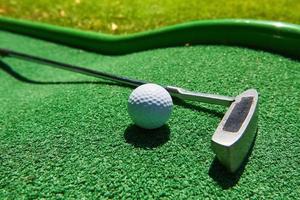 Golf ball and Golf Club on Artificial Grass photo