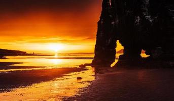 Is a spectacular rock in the sea on the Northern coast of Iceland. Legends say it is a petrified troll. On this photo Hvitserkur reflects in the sea water after the midnight sunset.