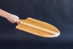 Wooden boards for pizza in hand woman photo