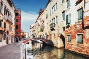 Gondolas on canal in Venice. Venice is a popular tourist destination of Europe. photo