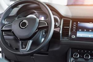 Luxury car Interior - steering wheel, shift lever and dashboard photo