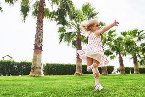 baby girl in a park near trees. photo