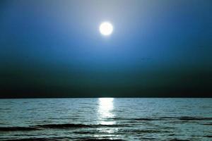 A blue night sky over the sea. photo