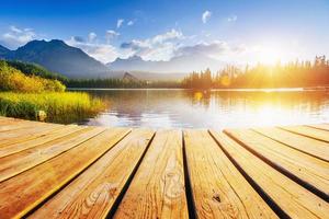 The sunrise over a lake in the park High Tatras. Shtrbske Pleso, Slovakia photo