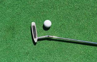 Mini-golf ball on artificial grass. Summertime. photo