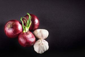 Blue purple onion and garlic isolated white on a black background photo