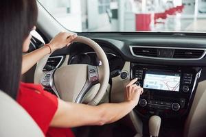 Smart car and internet of things IOT concept. Finger point to car 's console and icons popup out of screen photo