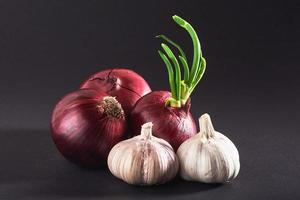 Blue purple onion and garlic isolated white on a black background photo