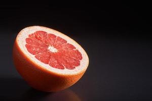 Grapefruit isolated on a black background photo