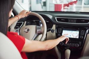 Smart car and internet of things IOT concept. Finger point to car 's console and icons popup out of screen photo