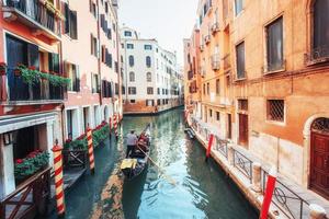 Gondolas on canal in Venice. Venice is a popular tourist destination of Europe. photo