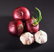Blue purple onion and garlic isolated white on a black background photo