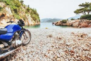 Panoramic views of the coastline. Motorcycle on the beach. The world of beauty photo
