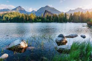 The sunrise over a lake in the park High Tatras. Shtrbske Pleso, Slovakia photo