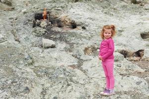 Chimera fire. Baby girl poses for the camera on a hill near Chirali. Kemer. Turkey. photo