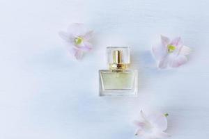 perfume and perfume bottle with pink flowers photo