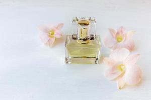perfume and perfume bottle with pink flowers photo