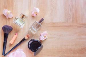 Perfume  and makeup cosmetics on wooden  background photo