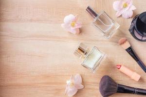 Perfume  and makeup cosmetics on wooden  background photo