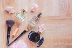 Perfume  and makeup cosmetics on wooden  background photo