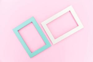 Simply design with empty pink and blue frame isolated on pink pastel colorful background. Top view, flat lay, copy space, mock up. Minimal concept. photo