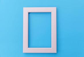 Simply design with empty pink frame isolated on blue pastel colorful background. Top view, flat lay, copy space, mock up. Minimal concept. photo