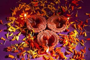 Clay diya lamps lit during Diwali Celebration. Greetings Card Design Indian Hindu Light Festival called Diwali photo