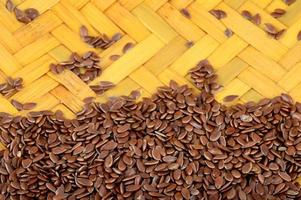 Close up of Flax Seeds in wooden basket on white background photo