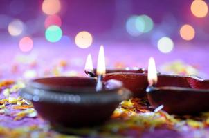 Clay diya lamps lit during Diwali Celebration. Greetings Card Design Indian Hindu Light Festival called Diwali photo