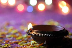 Clay diya lamps lit during Diwali Celebration. Greetings Card Design Indian Hindu Light Festival called Diwali photo