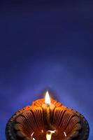 Clay diya lamps lit during Diwali Celebration. Greetings Card Design Indian Hindu Light Festival called Diwali photo