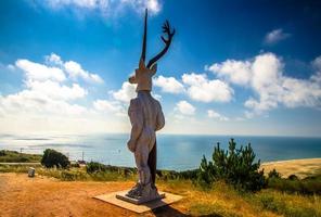 Nazare, Portugal - June 24, 2017 The Legend of Nazare statue monument view of the Atlantic ocean photo