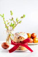 Sweet Easter cake panettone with icing and golden eggs. photo