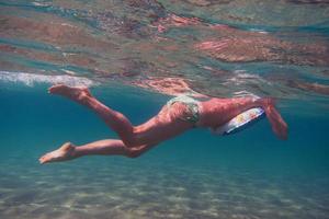 woman in bikini floating in sea