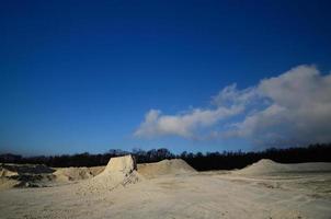 white limestone quarry in the forest photo
