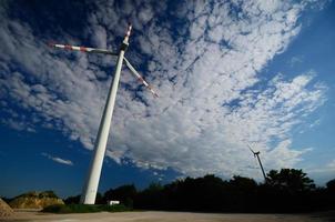 two wind turbines and clouds photo