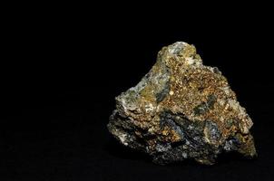 stone with pyrite on black background photo