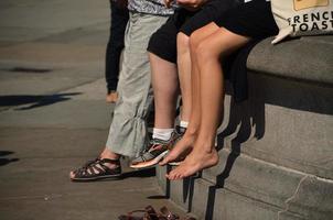 people sitting on fountain in city photo