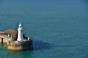 white lighthouse on the sea