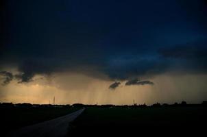 road with thunderstorm and rain photo