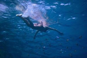 woman in bikini swimming in sea photo